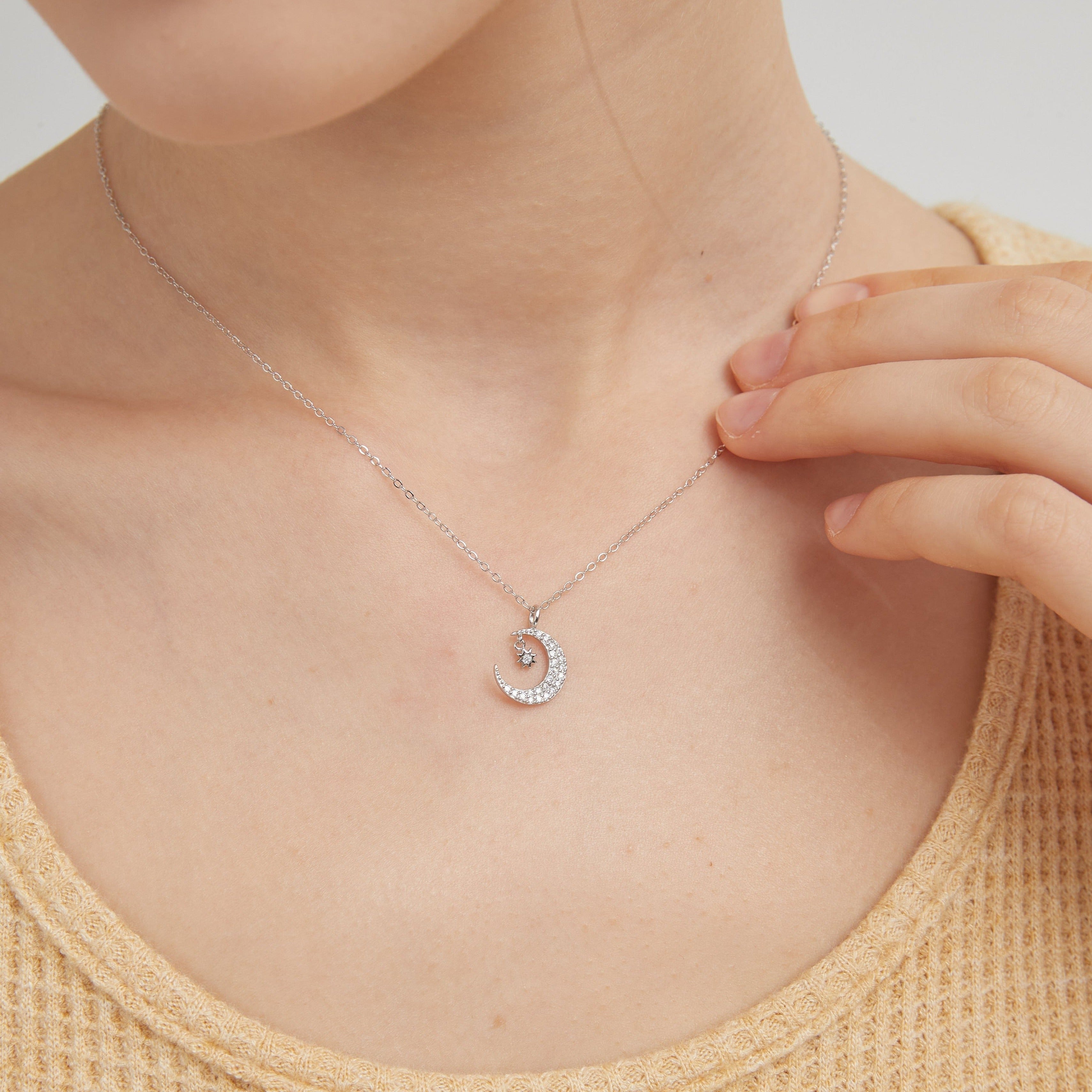 STMG Star on Crescent Moon Necklace in silver on neck