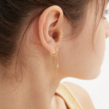 Chain Tassel Dangle Hoops in gold on ear