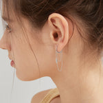 Chain Tassel Dangle Hoops in silver on ear