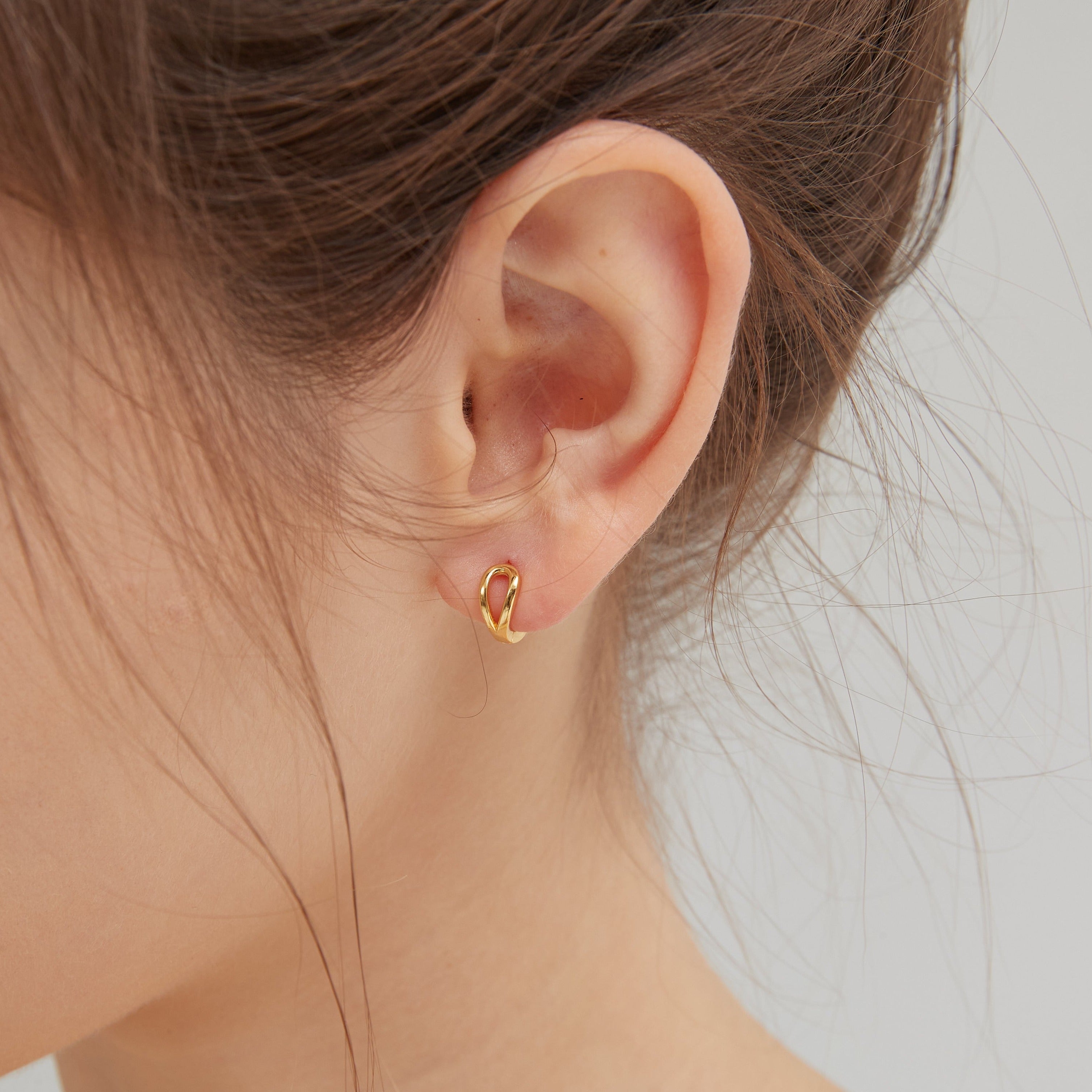 Geometric Droplet Hoops in gold on ear