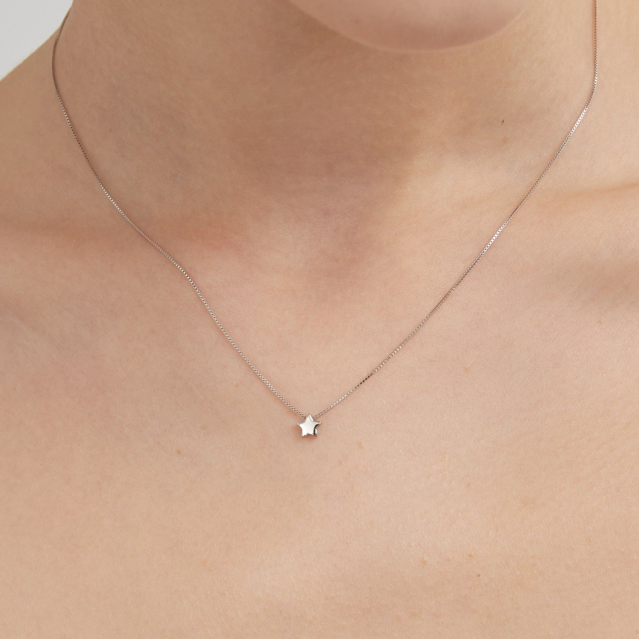 STMG Minimalist Star Necklace on neck