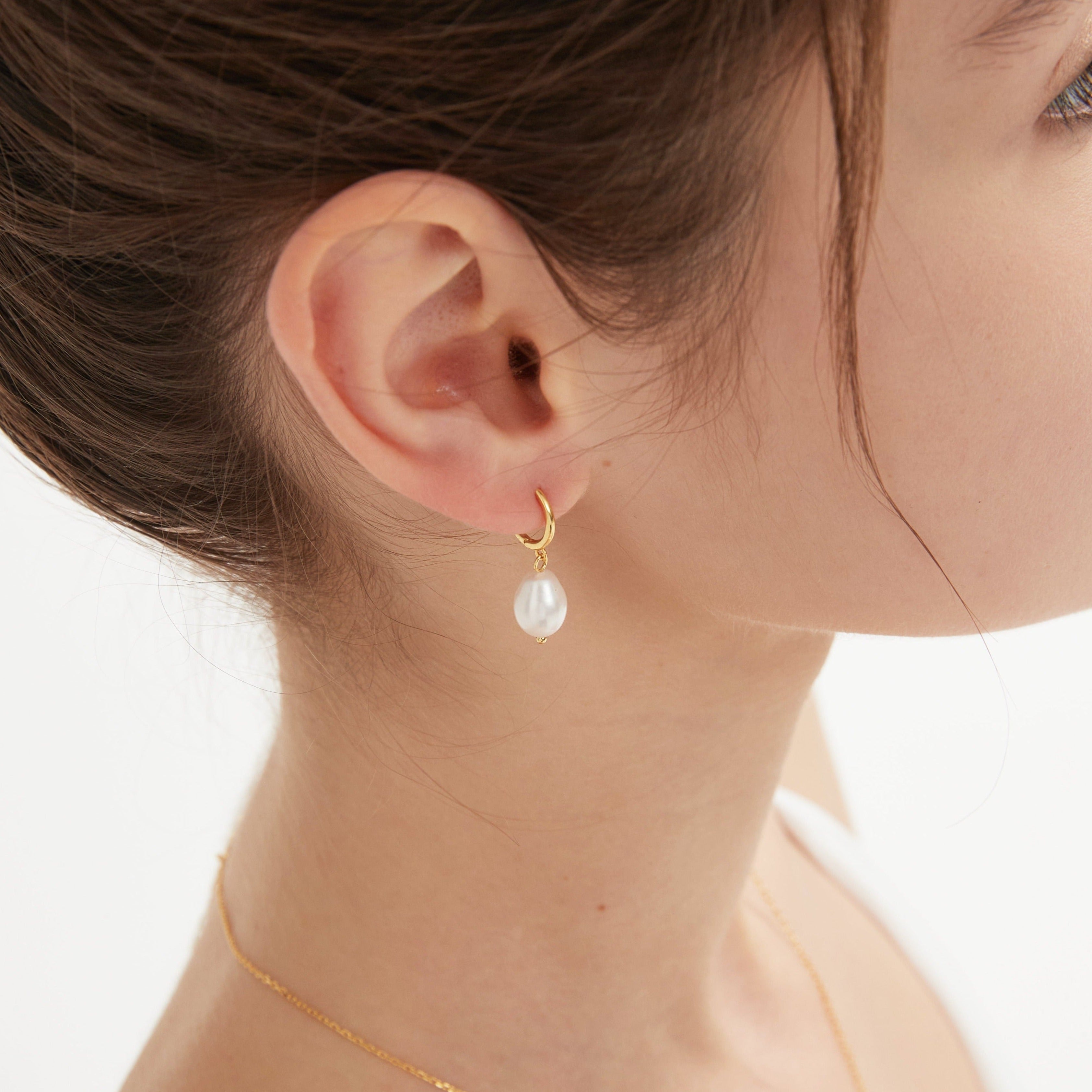 STMG Natural Pearl Dangle Hoops in gold on ear