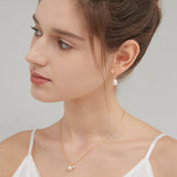 STMG Natural Pearl Dangle Hoops in gold with pearl necklace on neck