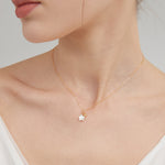 STMG Skinny Star Necklace in gold on neck