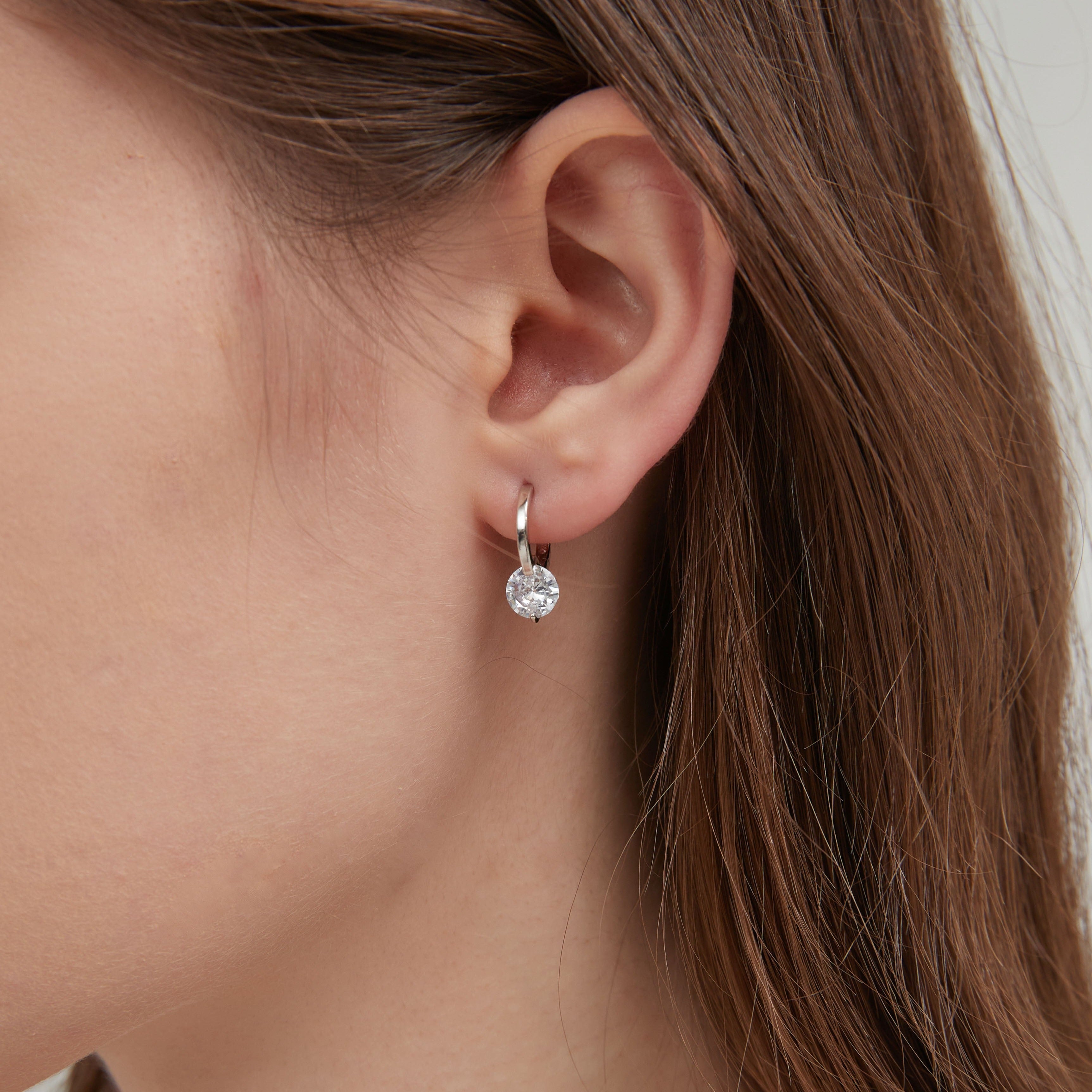 STMG Sparkly Crystal Hoops in silver on ear