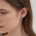 Emerald Green Hoops in silver on ear