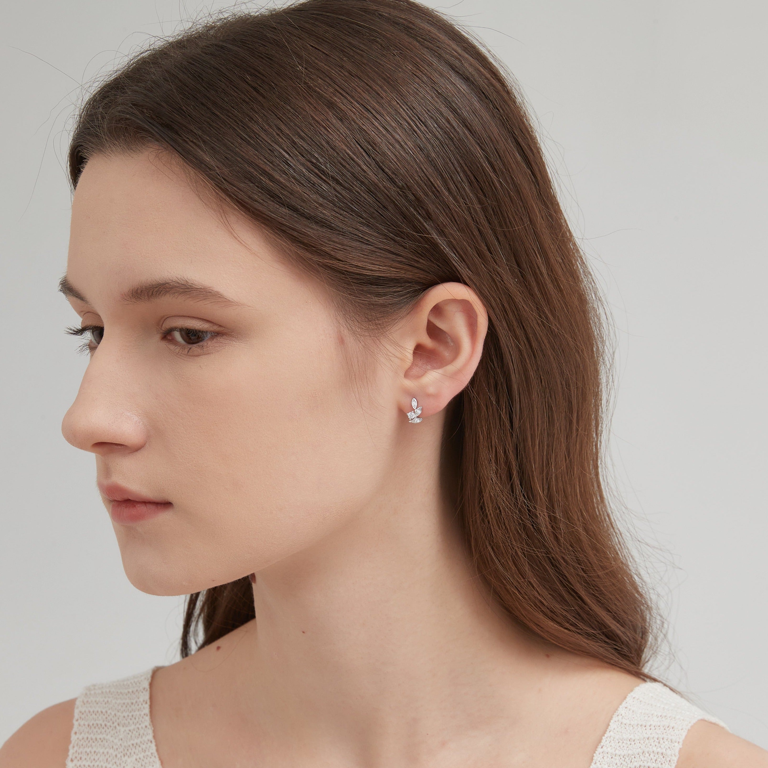 STMG Tiny Olive Leaf Hoops in silver on ear