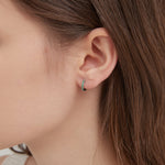 STMG Green Emerald Hoops in silver on ear