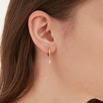 STMG Lightning Bolt Dangle Hoops in gold on ear