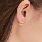 Geometric Star Hoops in gold on ear