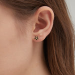 STMG Tiny Black Flower Stud Earrings on ear