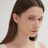 Bird and Feather Stud Earrings on ear