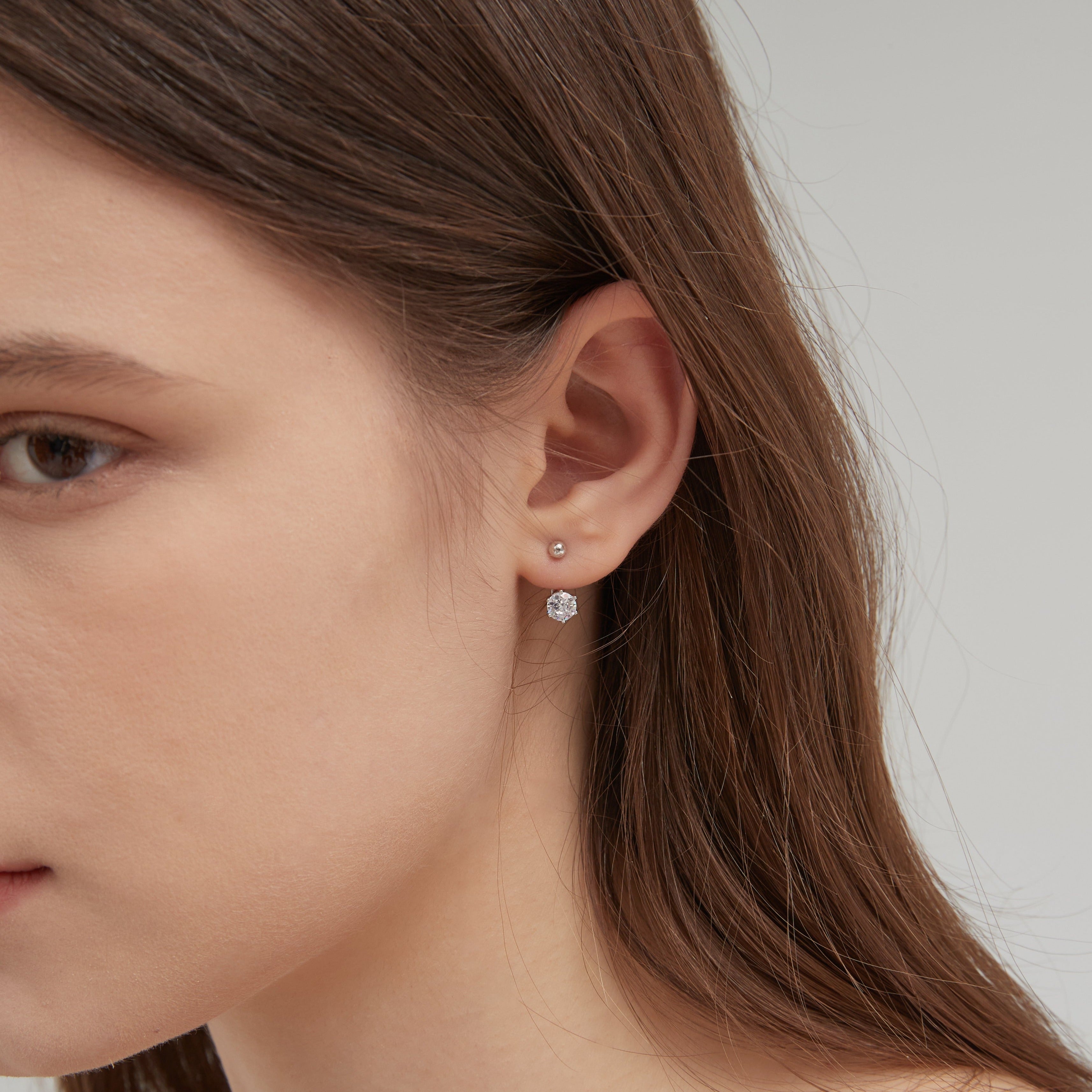 Diamond Stud Earrings in silver on ear