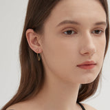 Cable Chain Dangle Earrings in gold on ear