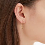 Cable Chain Dangle Earrings in gold on ear