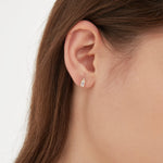 Emerald Cut Diamond Stud Earrings in gold on ear