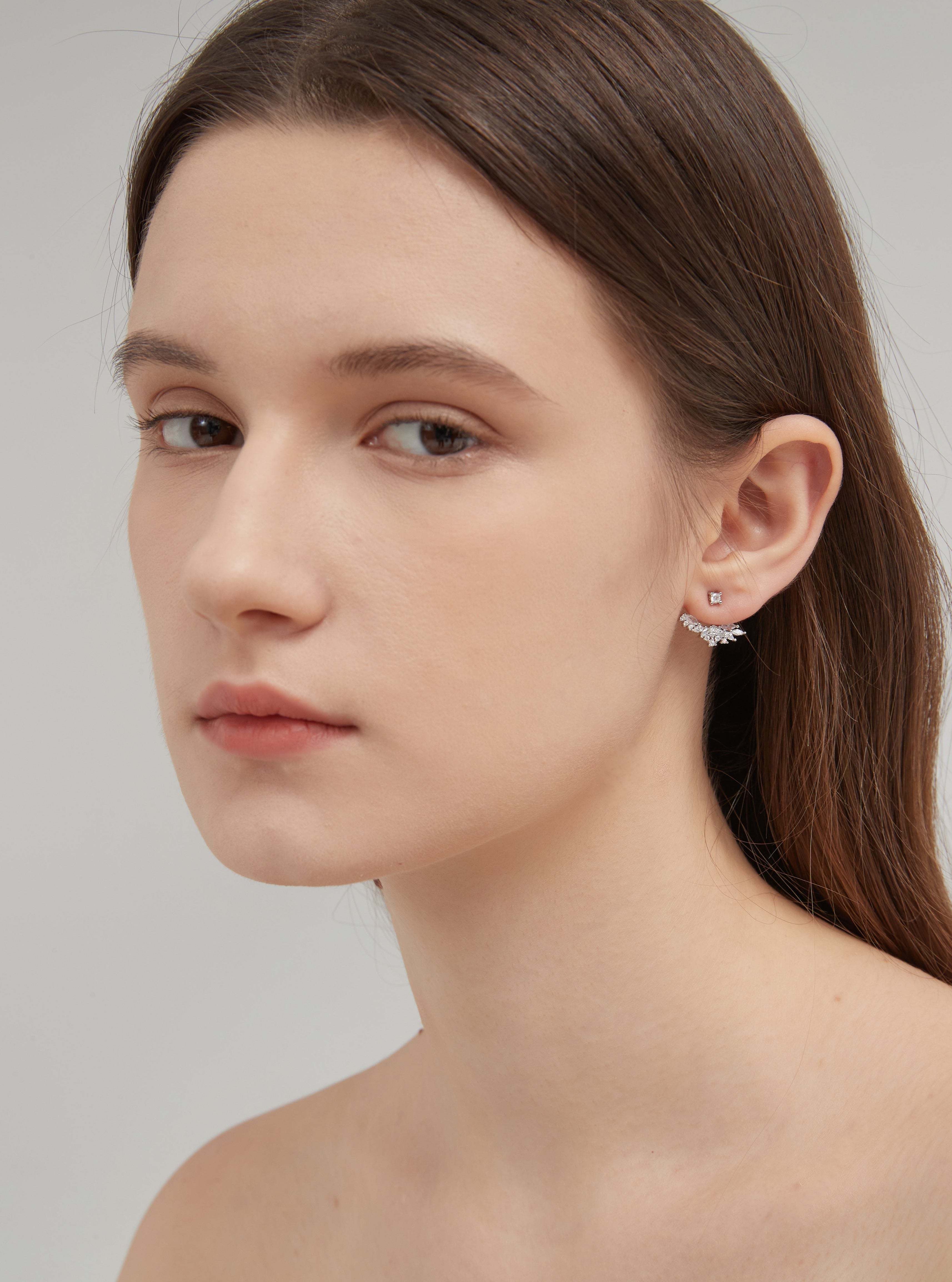 Angel Wing Stud Earrings in silver on ear