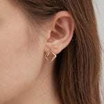 STMG Minimalist Rhombus Stud Earrings in champagne gold on ear