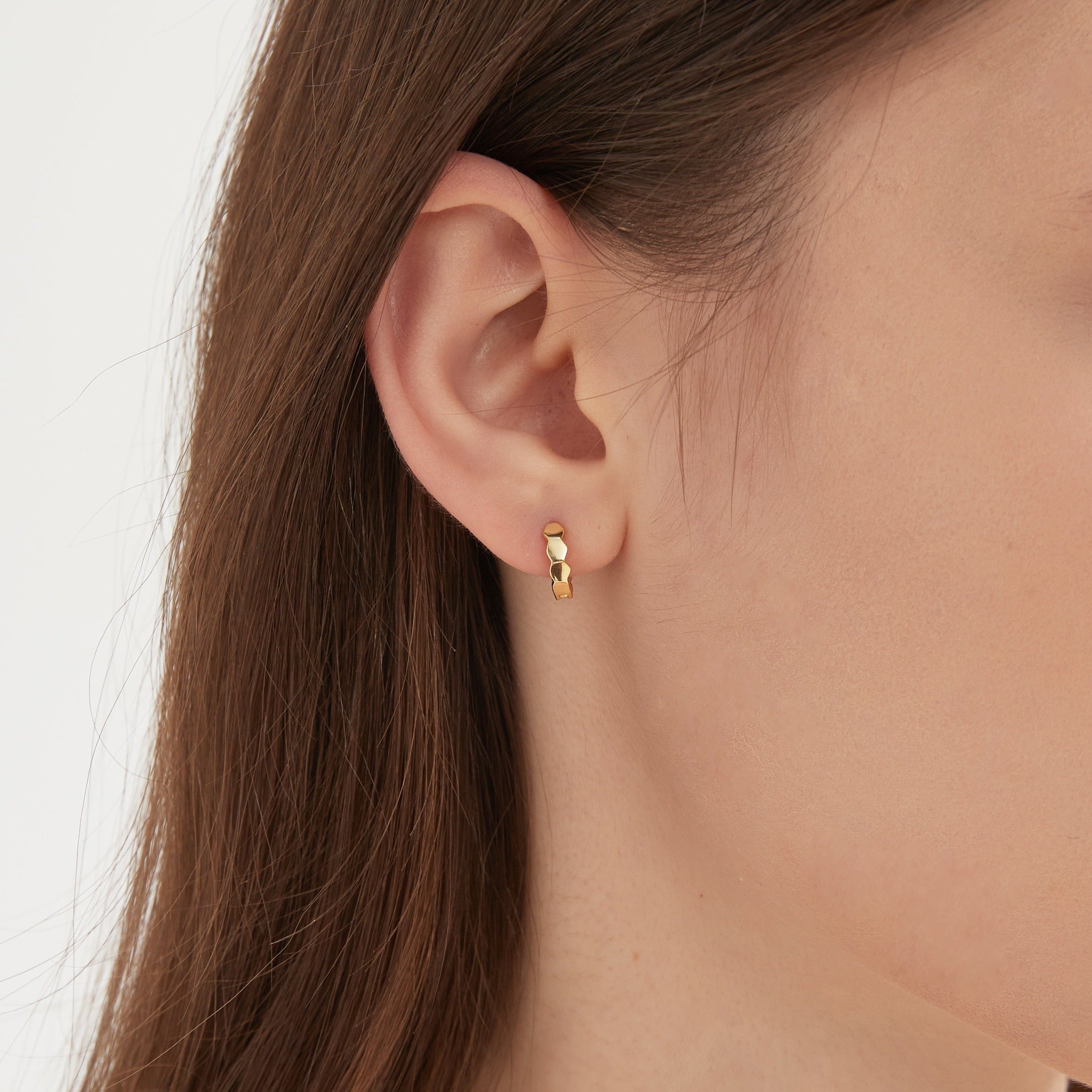 STMG Minimalist Hexagon Hoops in gold on ear