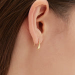 Droplet Hook Earrings in gold on ear