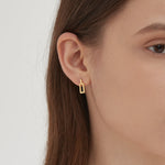 STMG Rectangle Dangle Earrings in gold on ear