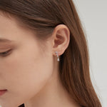 STMG Pear Cut  Diamond Dangle Earrings in silver on ear