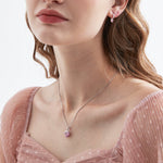 STMG Pink Heart Necklace on neck with matching earrings on ear