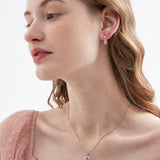 STMG Pink Heart Hoops on ear with matching necklace on neck