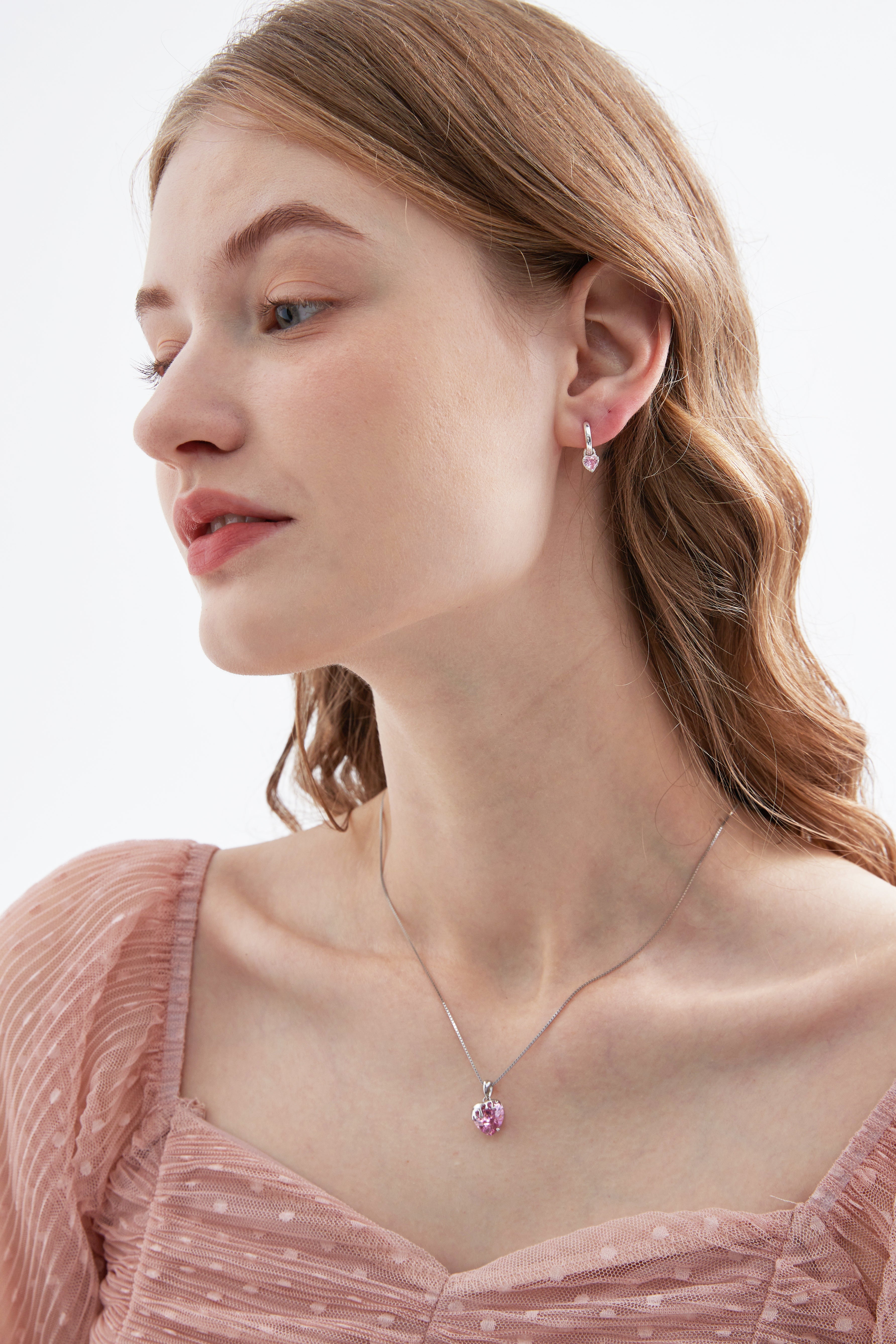 STMG Pink Heart Hoops on ear with matching necklace on neck