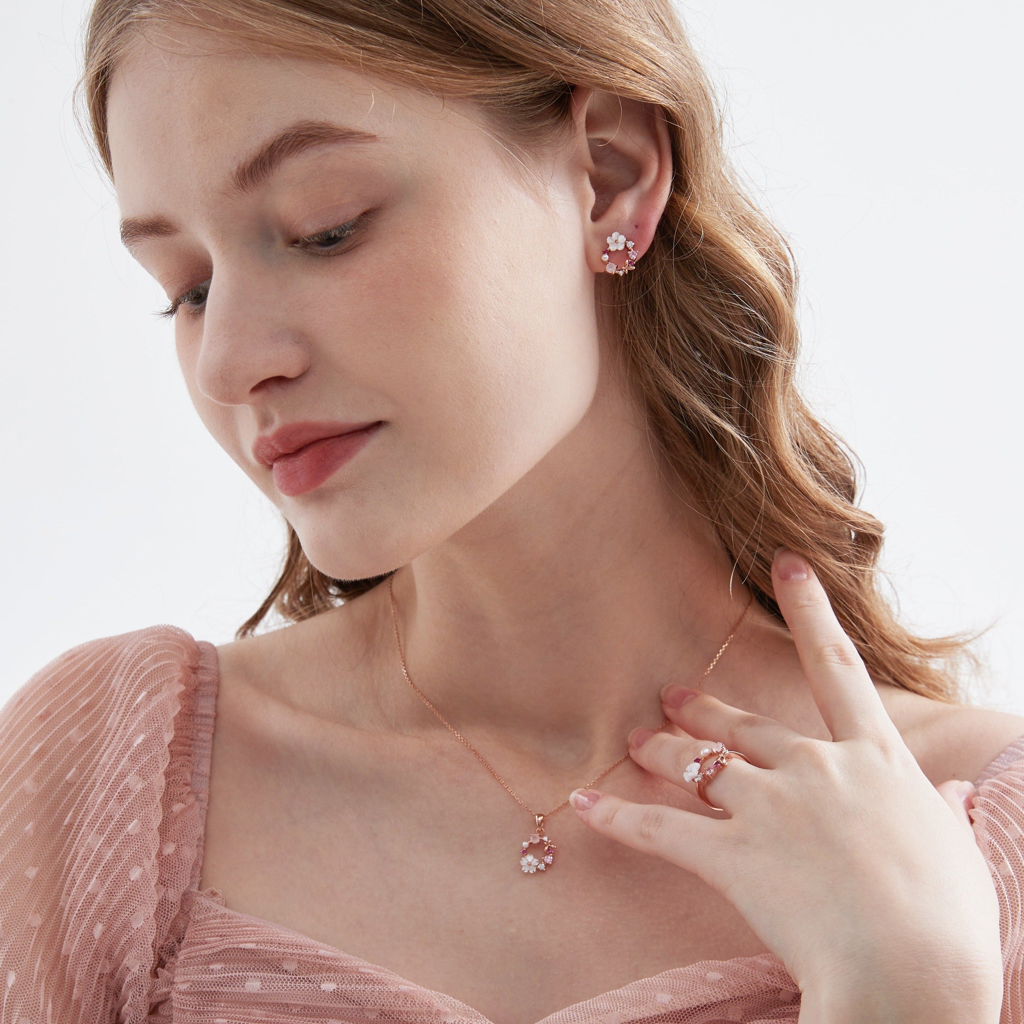 Flower Wreath Necklace on neck with earrings and ring on hand