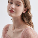 STMG Tiny Daisy Necklace on neck with matching earrings on ear