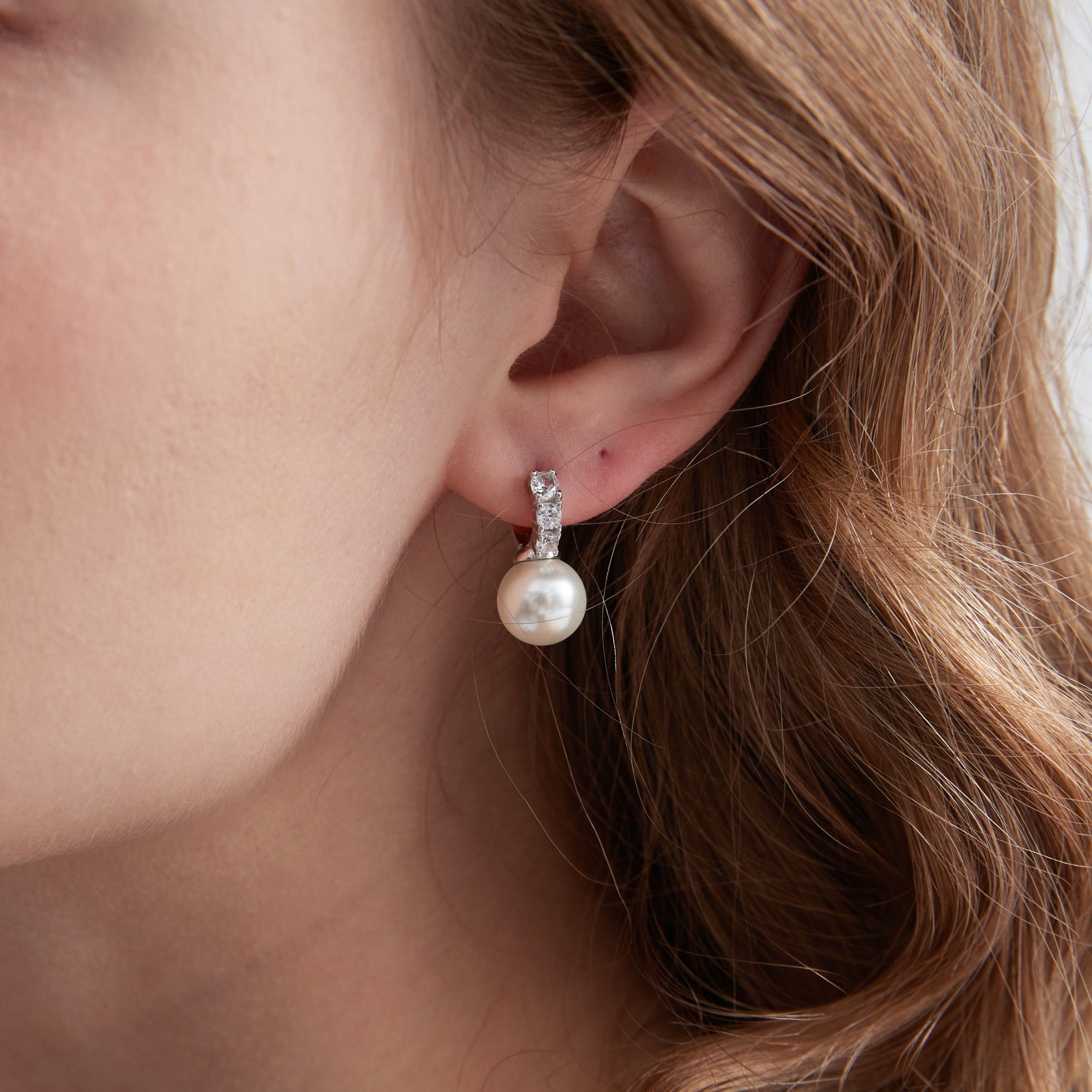 STMG Pearl Dangle Hoops in silver on ear