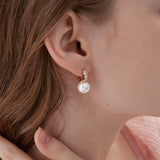 STMG Pearl Dangle Hoops in champagne gold on ear