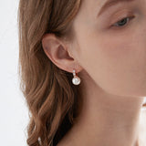 STMG Pearl Dangle Hoops in champagne gold on ear