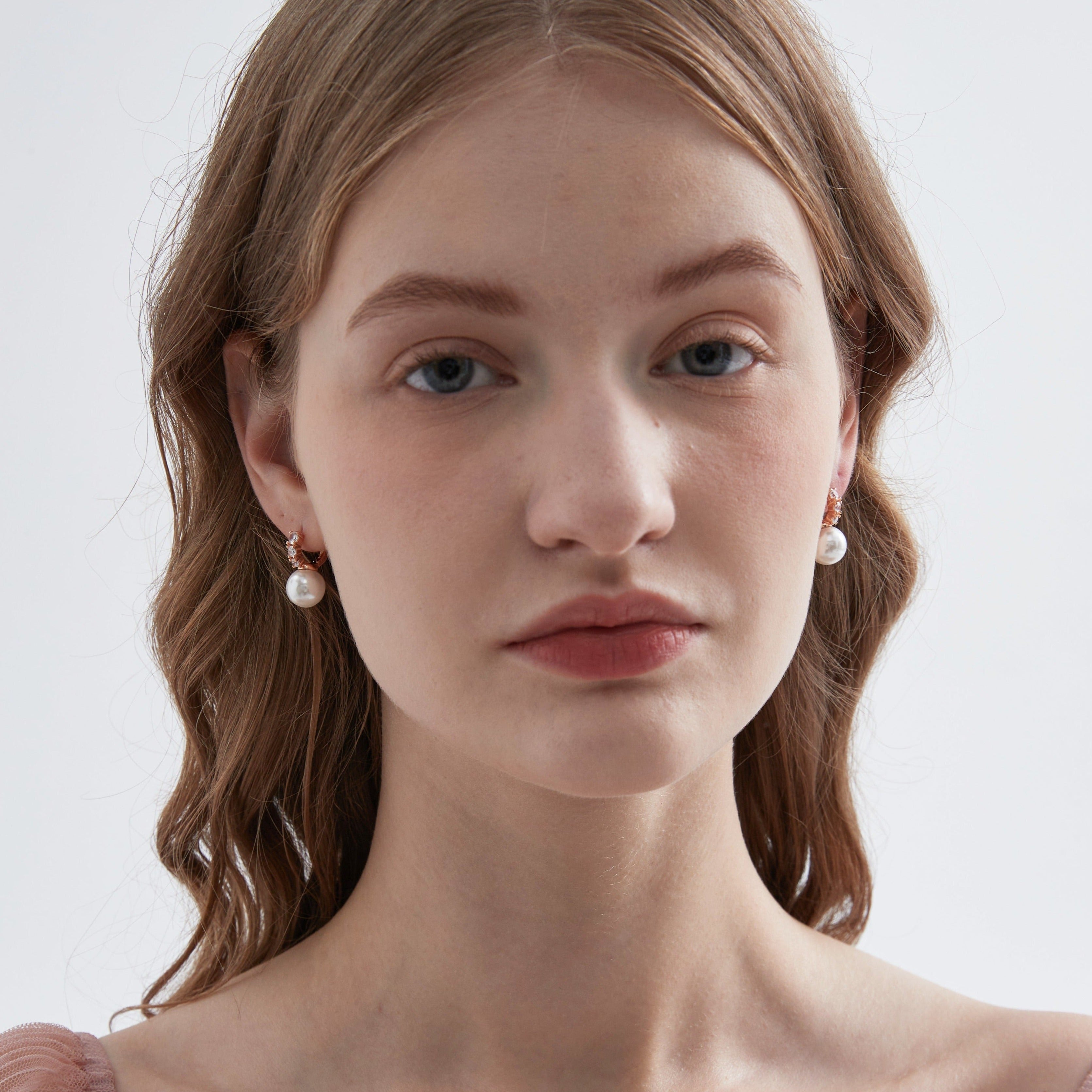 STMG Pearl Dangle Hoops in champagne gold on ear