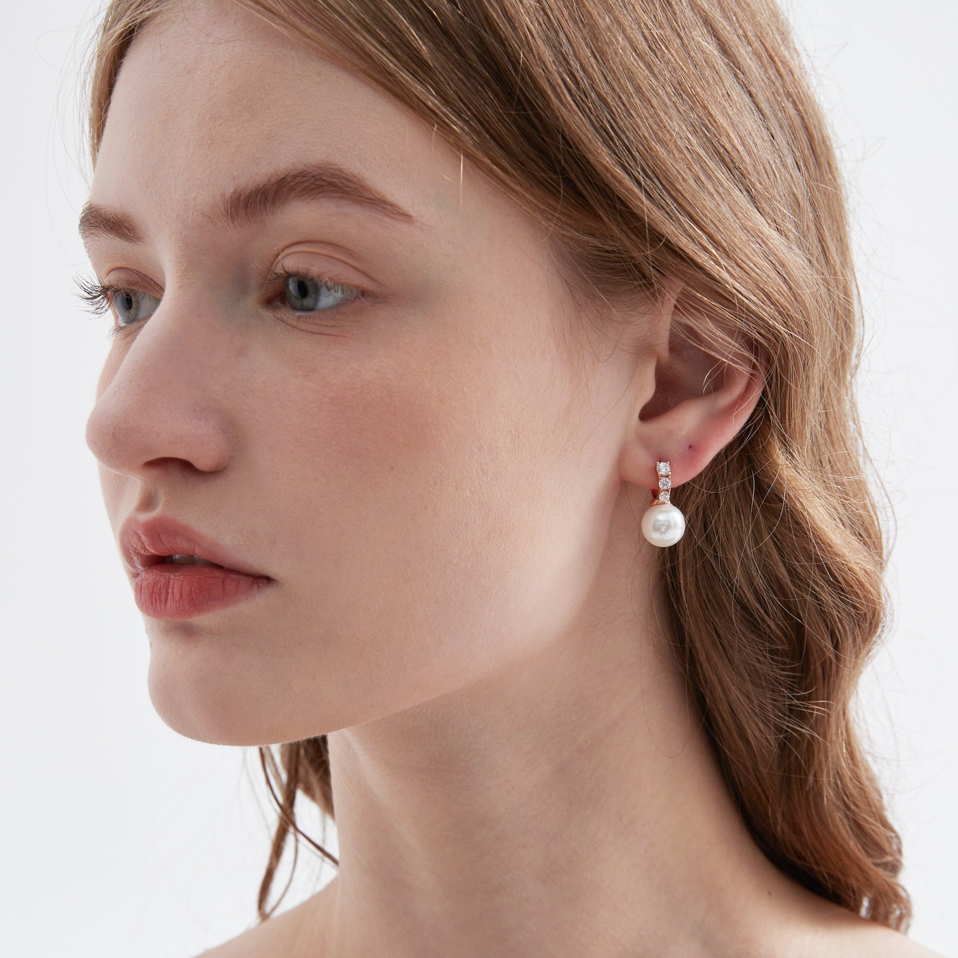 STMG Pearl Dangle Hoops in champagne gold on ear