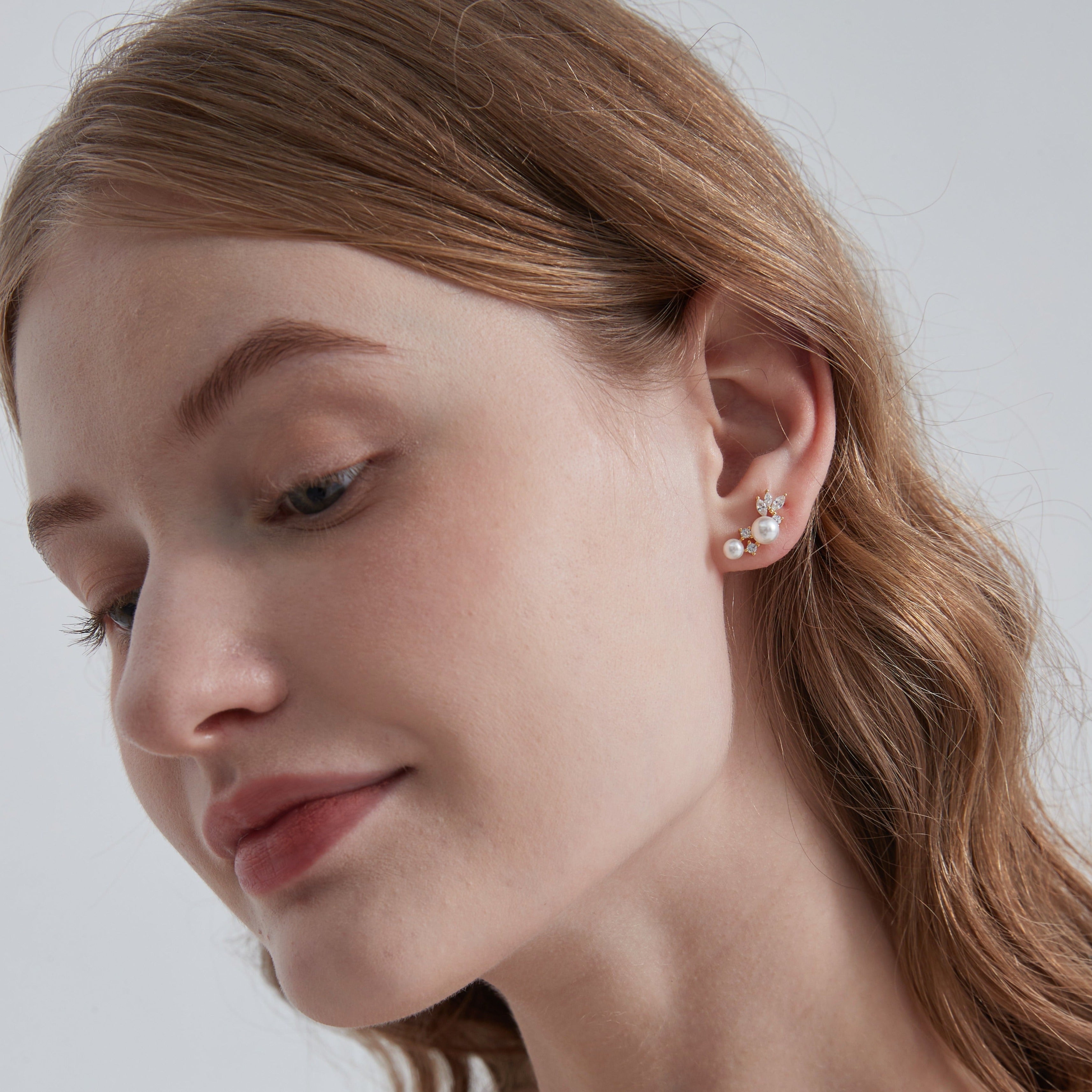 STMG Pearl Stud Earrings in gold on ear