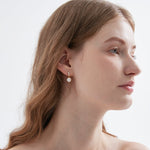 STMG Pearl Dangle Earrings in gold on ear