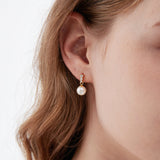 STMG Pearl Dangle Earrings in gold on ear