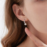 STMG Minimalist Pearl Hoops in silver on ear