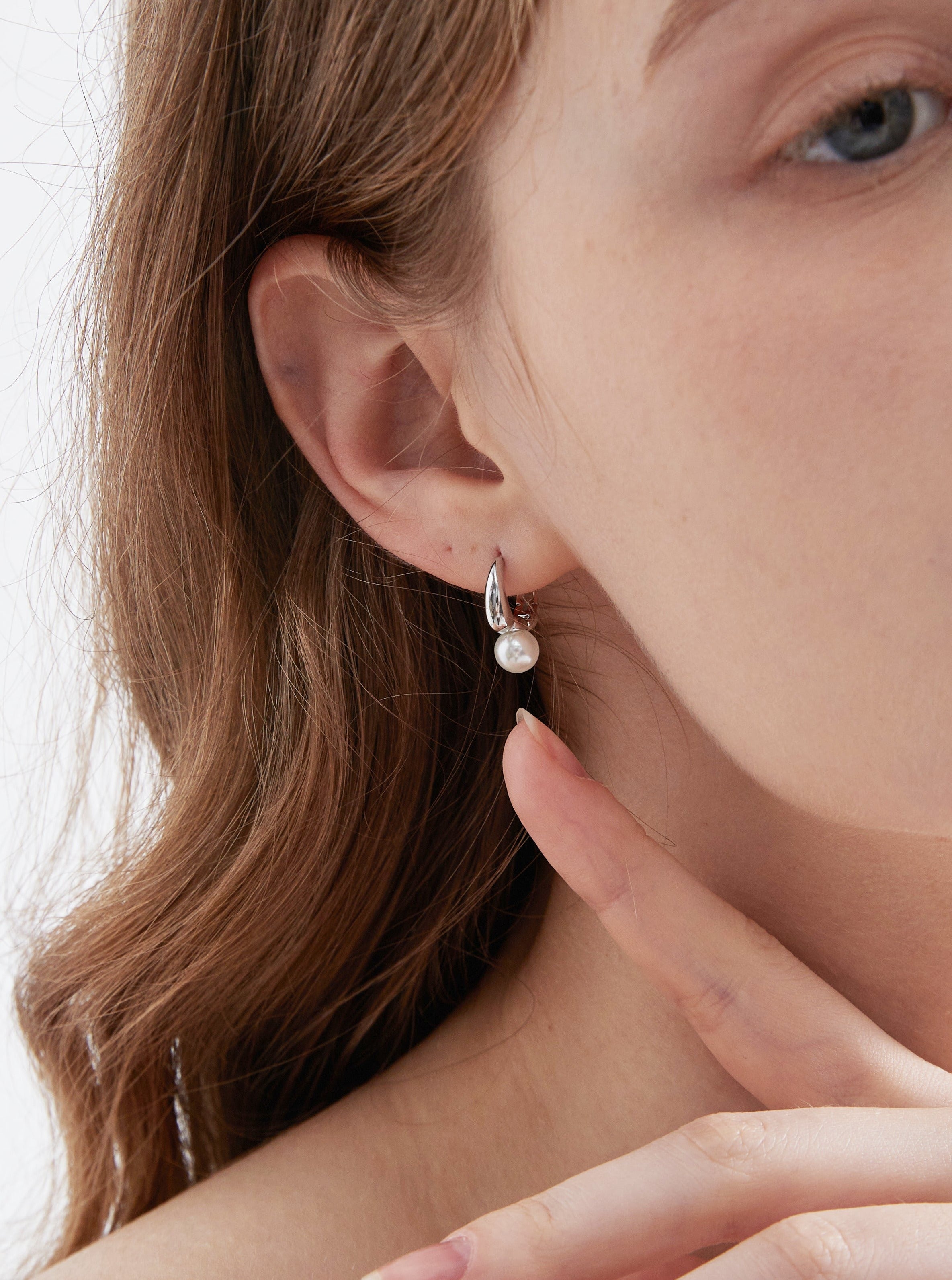 STMG Minimalist Pearl Hoops in silver on ear