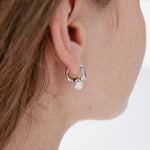 STMG Minimalist Pearl Hoops in silver on ear