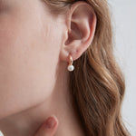 STMG Minimalist Pearl Hoops in champagne gold on ear