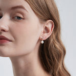 STMG Natural Pearl Dangle Earrings on ear