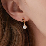 STMG Pearl Dangle Earrings on ear