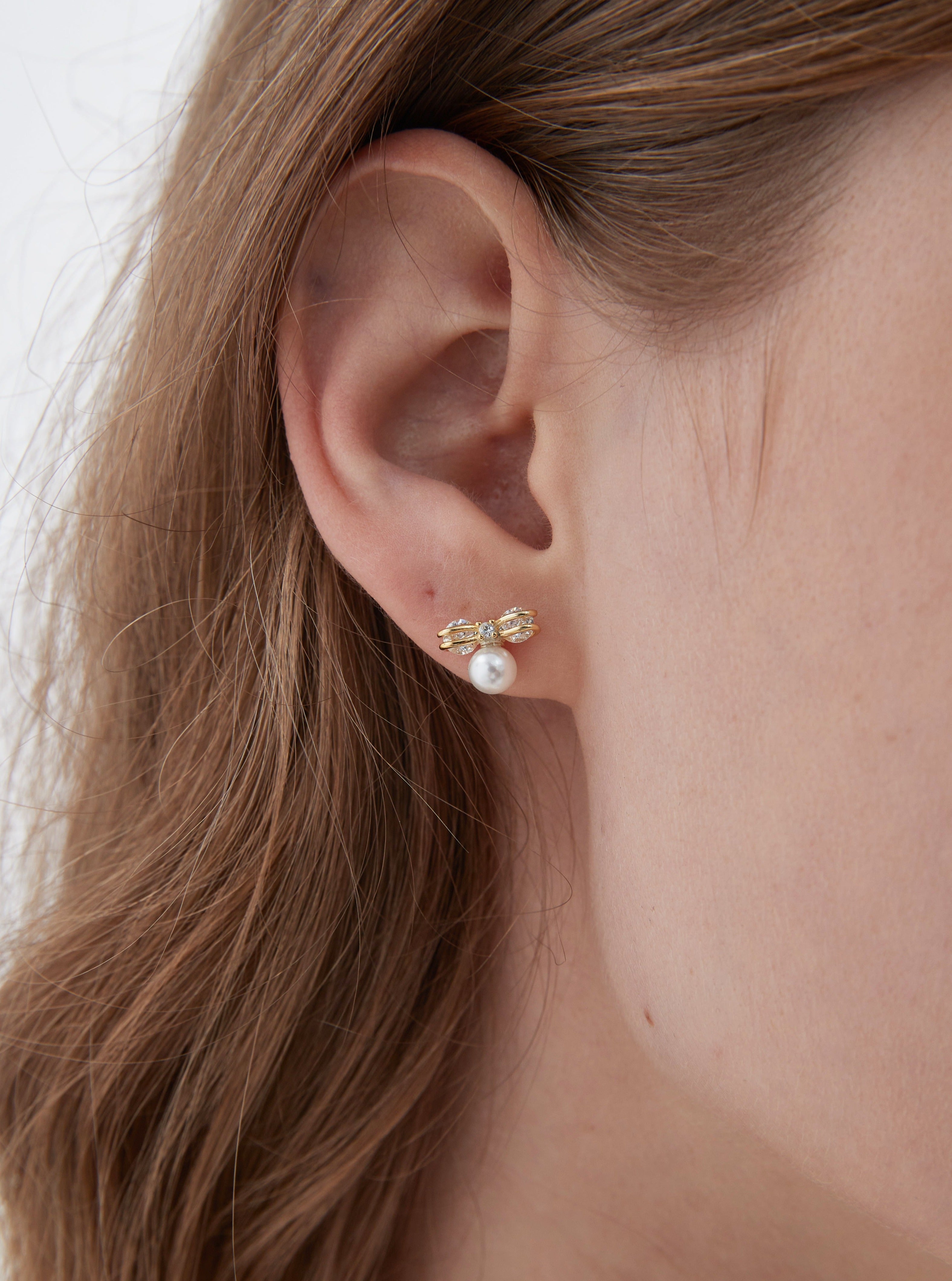 STMG Pearl on Bowknot Stud Earrings in gold on ear