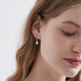 STMG Pearl Dangle Hoops in gold on ear