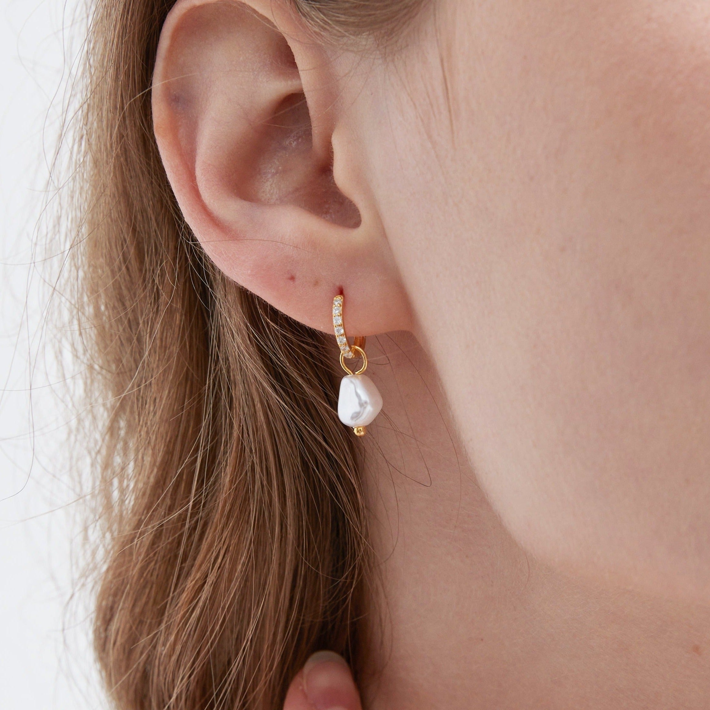 STMG Pearl Dangle Hoops in gold on ear