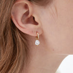 STMG Pearl Dangle Hoops in gold on ear