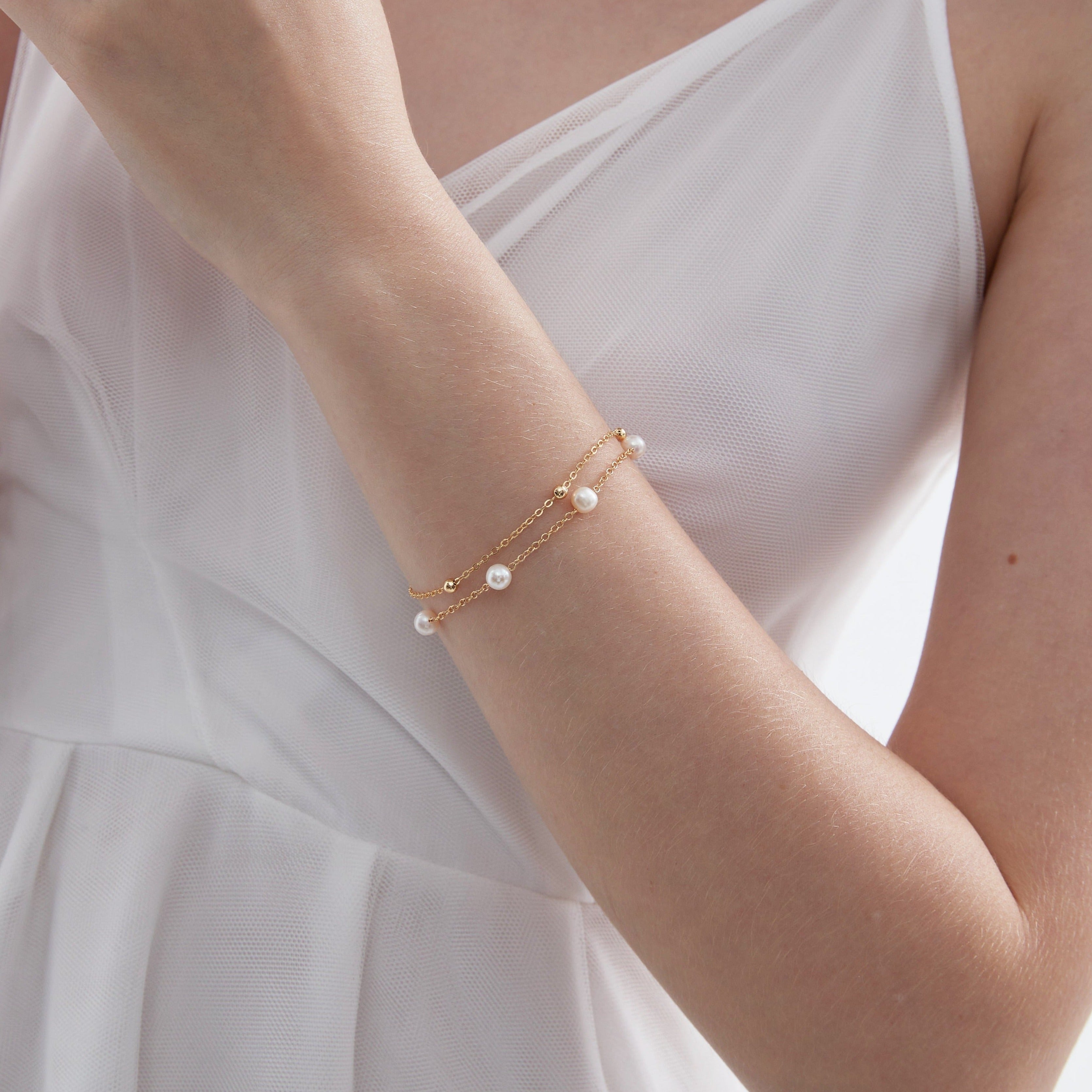 Duo Layer Natural Pearl Bracelet in gold on hand